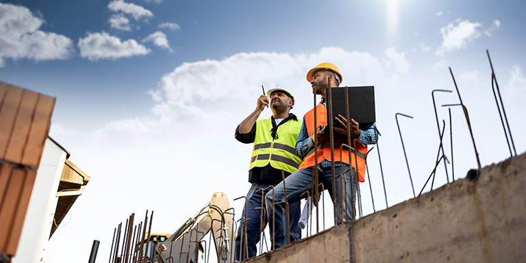 two construction workers planning