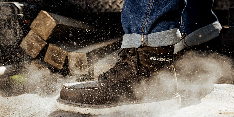 Wolverine steel toe boots kicking up dust